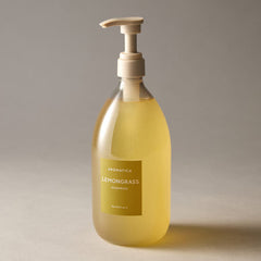 Bottle of Aromatica Lemongrass shampoo with pump on a neutral background