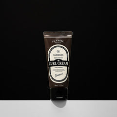 Tube of Curl Cream with a black and white label on a black background