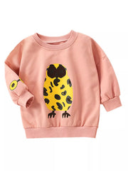 A pink long-sleeve sweatshirt for kids, featuring a large yellow owl graphic with black spots on the front and a smaller matching graphic on the left sleeve, shown against a plain white background.