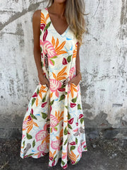 Woman wearing a colorful floral dress against a textured wall.