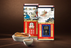 Two large tea tins with traditional designs on a brown background