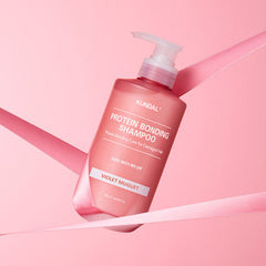 Kundal Protein Bonding Shampoo bottle on a pink background
