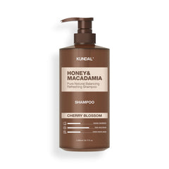 Kundal Honey & Macadamia shampoo bottle on a white background