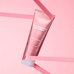Pink hair treatment tube on a pink background
