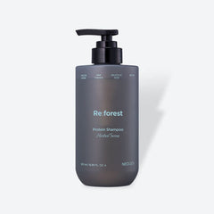 Shampoo bottle labeled 'Re:forest' on a light gray background