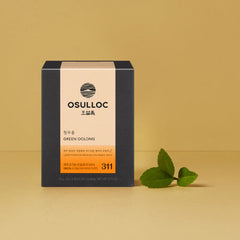 OSULLOC Green Oolong tea box with green leaves on a beige background